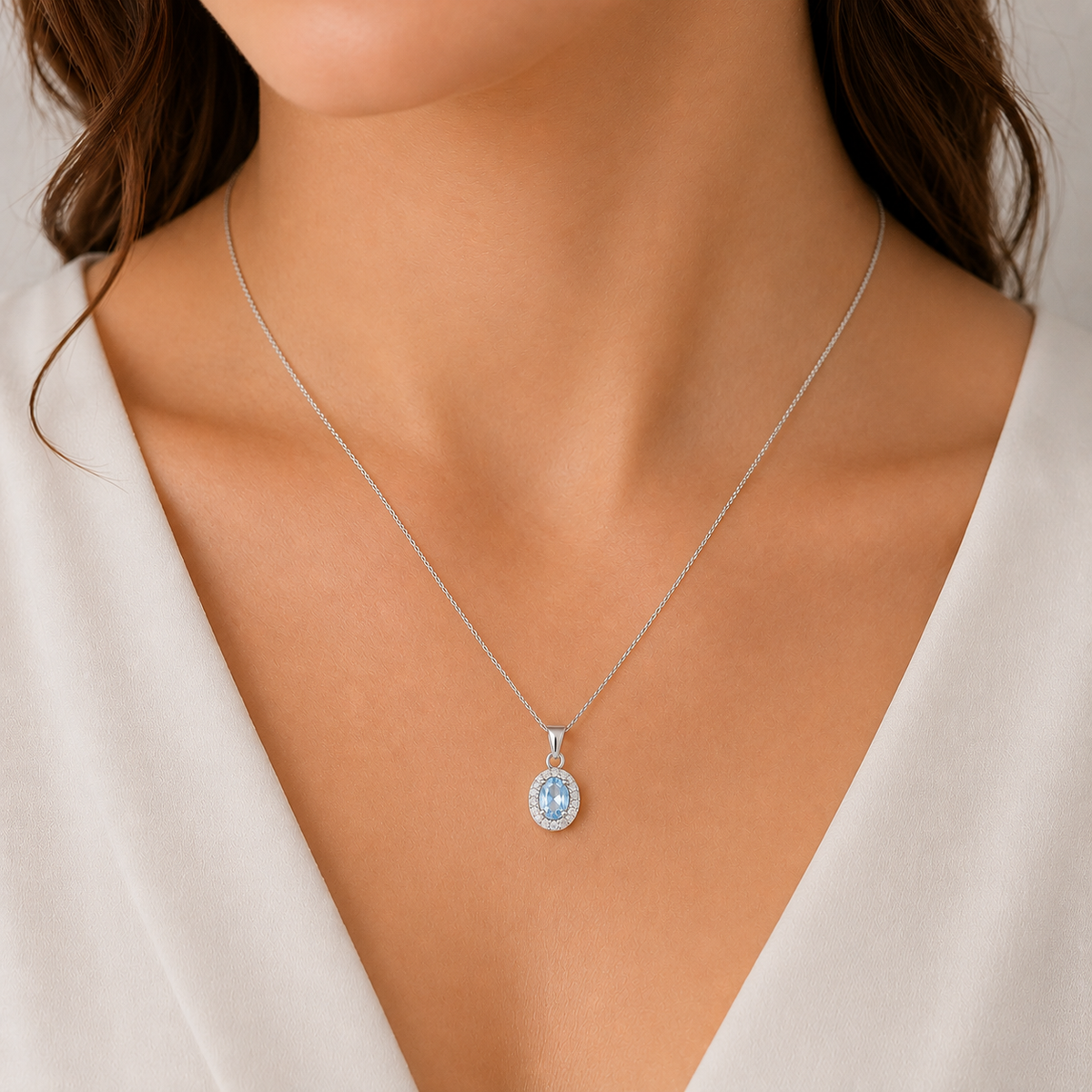 Sterling Silver light blue cubic zirconia oval halo pendant