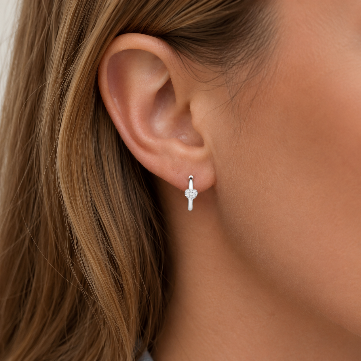 Sterling Silver polished hoops with cubic zirconia heart